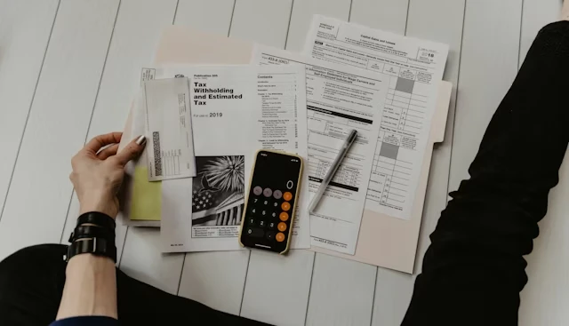 Calculator on tax forms and financial paperwork